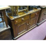 A XIX Century Mahogany Cupboard, with twin drawers over cupboard doors, curved corners on plinth