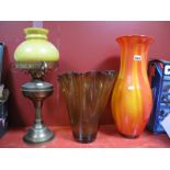 An Oil Lamp, red and amber streaked glass vase, yellow glass vase with wavy rim, 32cm high. (3)