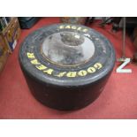 An Eagle Goodyear Racing Tyre as a Coffee Table, 64cm wide.