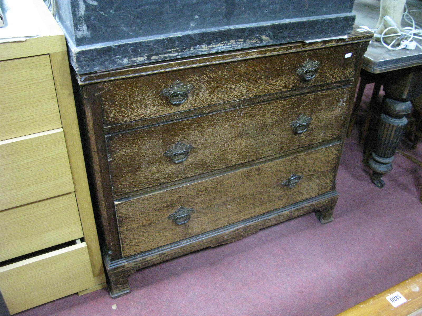 A 1920's Oak Chest of Three Drawers, with canted corners and bracket feet, 93cm wide.