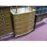 A Walnut Bow Fronted Chest of Drawers, with a low back, five graduated drawers, on cabriole legs.