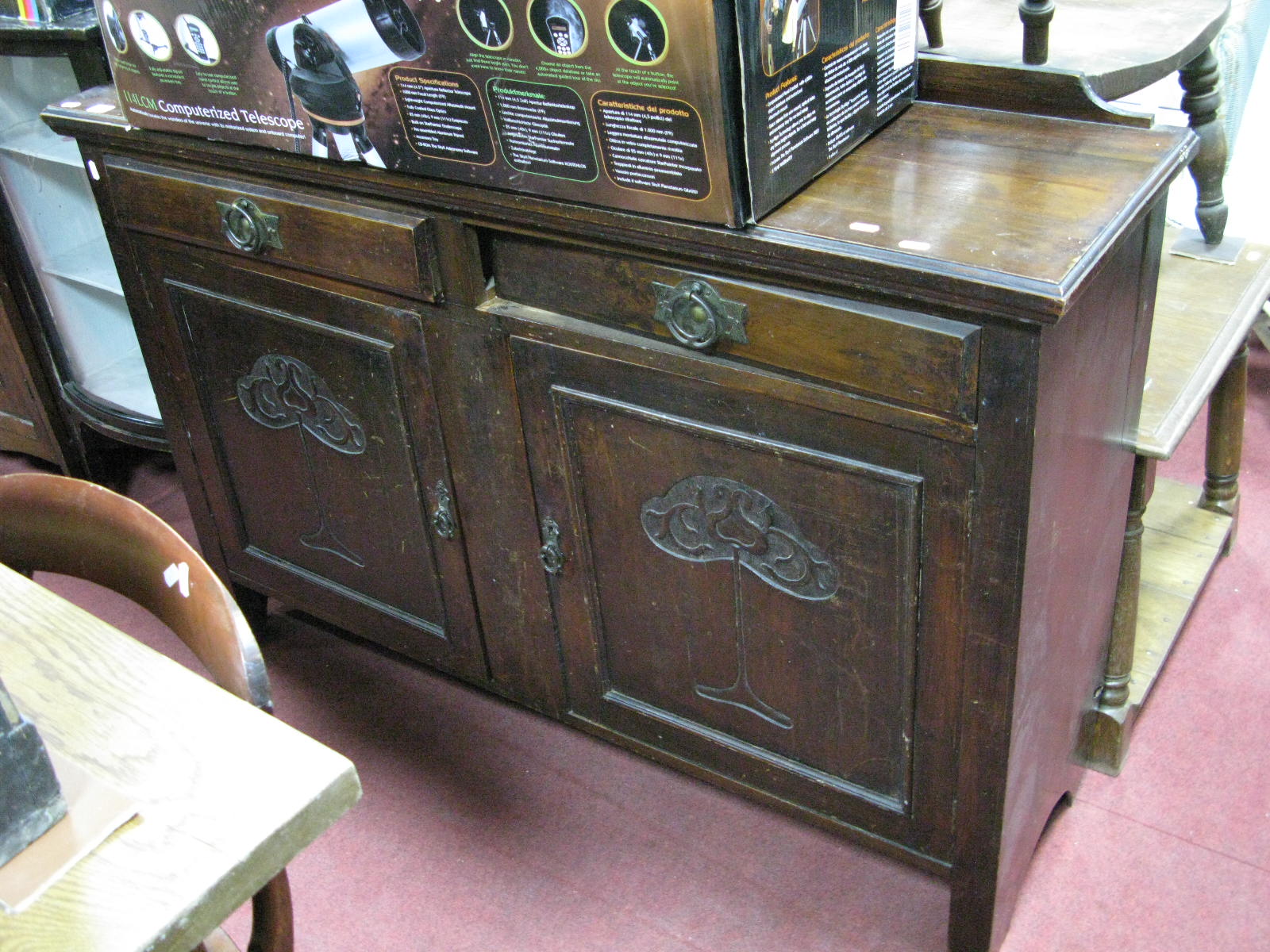 A Walnut Sideboard, with Art Nouveau stylised carving to twin doors, 135cm wide.