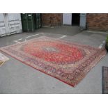 A Mid XIX Century Wool Carpet with central motif in the Indian manner, all over floral decoration on