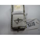 A Modern Marquise Cut Single Stone Diamond ring, high set between uniform inset shoulders,