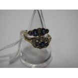 A 9ct Gold Sapphire and Diamond Dress Ring, collet set to the centre; together with another 9ct gold