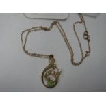 An Edwardian Pearl Set Pendant, of scroll design, claw set to the centre, stamped "15ct", on a