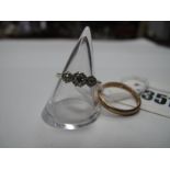 A Three Stone Diamond Ring, illusion set, stamped "18ctPLat"; a 9ct gold plain wedding band. (2)