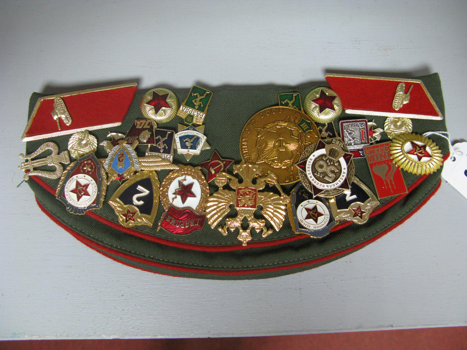 A Late XX Century Russian Side Cap, covered in Russian badges, and collar, insignia mainly