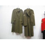 An ER II Army Greatcoat, 19512 Pattern, with buttons; Another, similar, with Sergeants stripes,