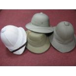 Three Mid XX Century Khaki Sun/Pith Helmets, and another in white.