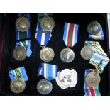 Late XX Century UN Medals, (9), and a UN beret badge, contained in a wooden display box.