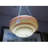 A 1930's Art Deco Ceiling Light Shade, with orange bands on a cream shade.