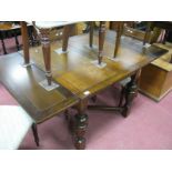 A 1920's Oak Draw Leaf Table, with cup and cover supports, block feet united by 'X' stretcher.