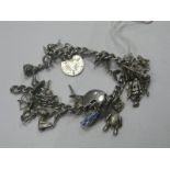 A Curb Link Charm Bracelet Suspending Assorted Charm Pendants, including articulated teddy bear,