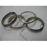 Four Hallmarked Silver Bangles, hinged to snap clasp each with engraved decoration. (4)