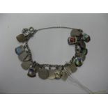 A Curb Link Bracelet, suspending numerous enamel shield souvenir charms.
