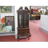 A XVIII Century Style Cabinet, with swan neck pediment, twin glazed doors, one long drawer over