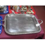 A Decorative Twin Handled Plated Tray, of rounded rectangular form with textured edge, raised on