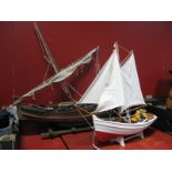 A Wooden Model Boat, with oars, mast and cotton sails, mounted on stand, overall length 77cm and a