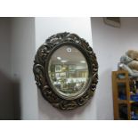 A XIX Century Oak Circular Wall Mirror, with scroll and pierced decoration, bevelled glass.