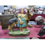 A 1930's Painted Plaster Model of a Standing Alsatian Beside a Young Girl with Basket, on