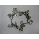 A Fancy Link Charm Bracelet, suspending assorted novelty charm pendants including bird cage,