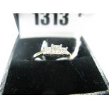 A Three Stone Princess Cut Diamond Ring, stamped "18K" and "50".