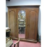 A XIX Century Mahogany Triple Wardrobe, with a central mirror, twin panelled doors, with internal