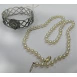 A Single Strand Uniform Pearl Bead Necklace; together with a hallmarked silver bangle, of openwork