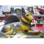 A 1930's Painted Plaster Model of a Seated Alsatian, on naturalistic base, length 53cm