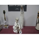 A Lladro Figure, of a boy and dog, and a Lladro figure of a nun. (2)
