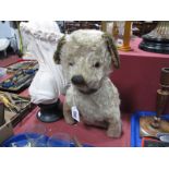 A Mid XX Century Straw Filled Seated Dog, well loved, with replacement ears and tail, with leather