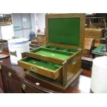 An Edwardian Oak Cutlery Cabinet, lift-up top, two drawers, campaign style side handles,