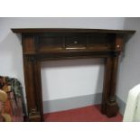 A 1920's Oak Fireplace, with a stepped pediment, three panelled back, on column supports, block