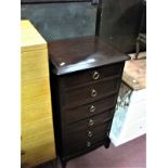 A Stag Chest of Drawers, with moulded edge, five small drawers, on square legs.
