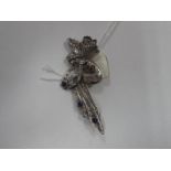 An Art Nouveau Style Fairy Brooch, of stylised design holding a flower, with inset highlights,