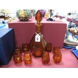An Art Deco Amber Glass Decanter and Stopper and Matching Tots, the decanter and stopper of
