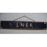 A L.N.E.R Blue Enamel Railway Sign, 109cm long, 15cm high, mounted on a wooden board, 112cm long,