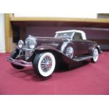 A Franklin Mint Model of a 1935 Duesenberg J550, appears complete, boxed.