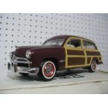 A Franklin Mint Model of a 1949 Woody Wagon, appears complete, boxed with paperwork.