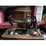 A Singer Sewing Machine, walnut cased.