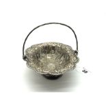 A Hallmarked Silver Swing Handled Basket, T.S, London 1881, of shaped textured oval form, raised