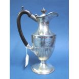 A Hallmarked Silver Water Jug, F&S, Birmingham 1916, of semi reeded form, on circular spreading