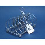 A Hallmarked Silver Seven Bar Toast Rack, John & Thomas Settle, Sheffield 1822, with central loop