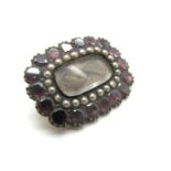 A XIX Century Hairwork Brooch, of rounded rectangular form, highlighted with seed pearls.