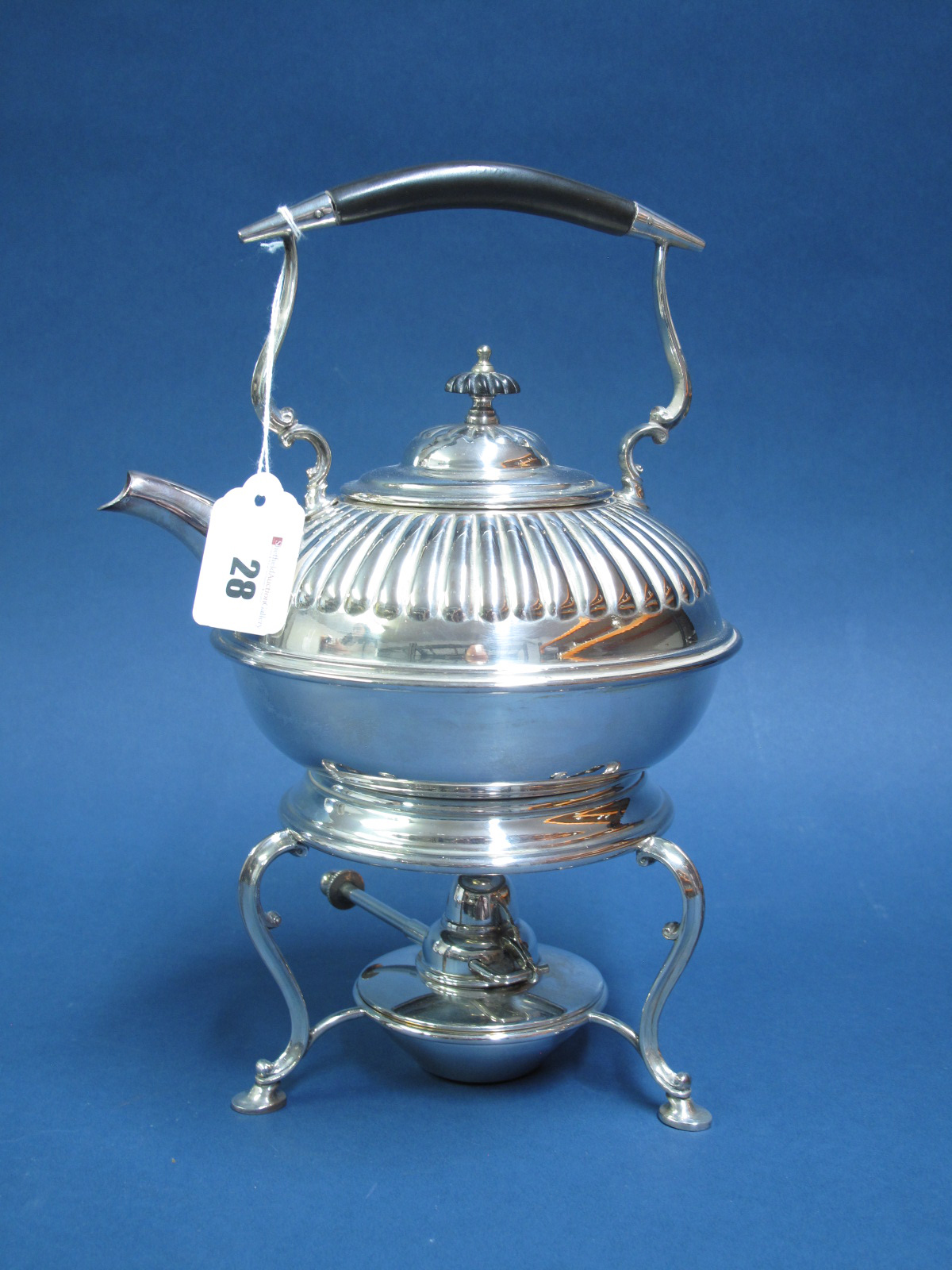 An Electroplated Tea Kettle on Burner Stand, of semi reeded form on plain scroll base, with