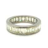 A Diamond Set Eternity Band, channel set throughout with uniform baguette cut stones, approximate