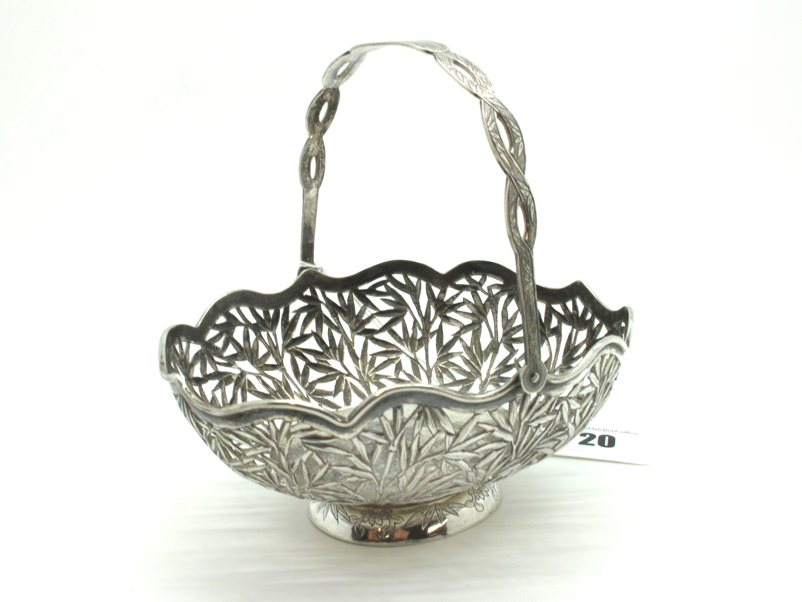 A Chinese Swing Handled Basket, of openwork bamboo design, on oval spreading base, stamped character