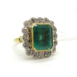 A Large 18ct Gold Emerald and Diamond Cluster Ring, the central (12x10mm) emerald cut emerald collet