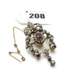 An Edwardian Ruby and Diamond Set Brooch, as a floral garland set throughout with old cut